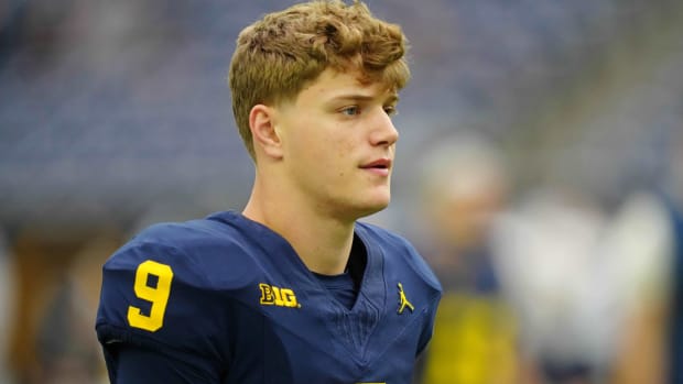 Michigan quarterback J.J. McCarthy looks on without a helmet before a game.